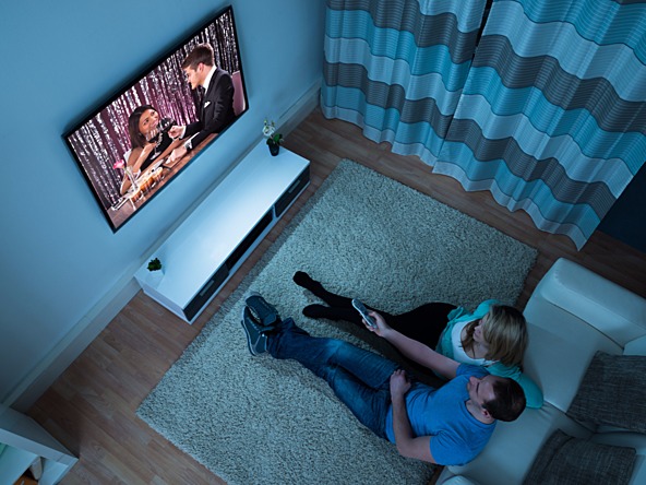 couple watching TV in their living room